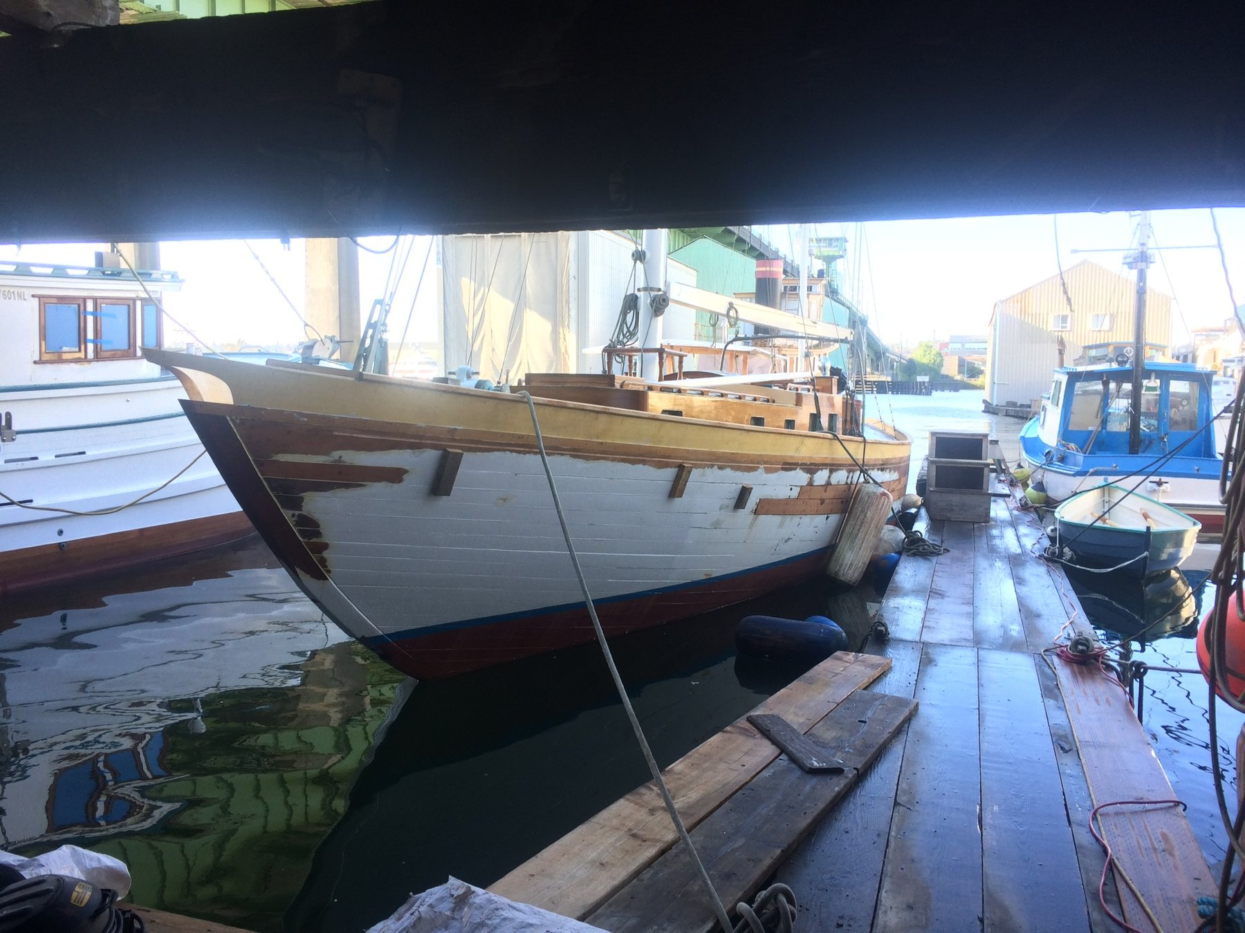 The classic 1946 Philip Rhodes-designed Merry Maiden rests at her moorings in Puget Sound, her graceful wooden hull and traditional lines showcasing the enduring elegance of mid-century yacht design.
