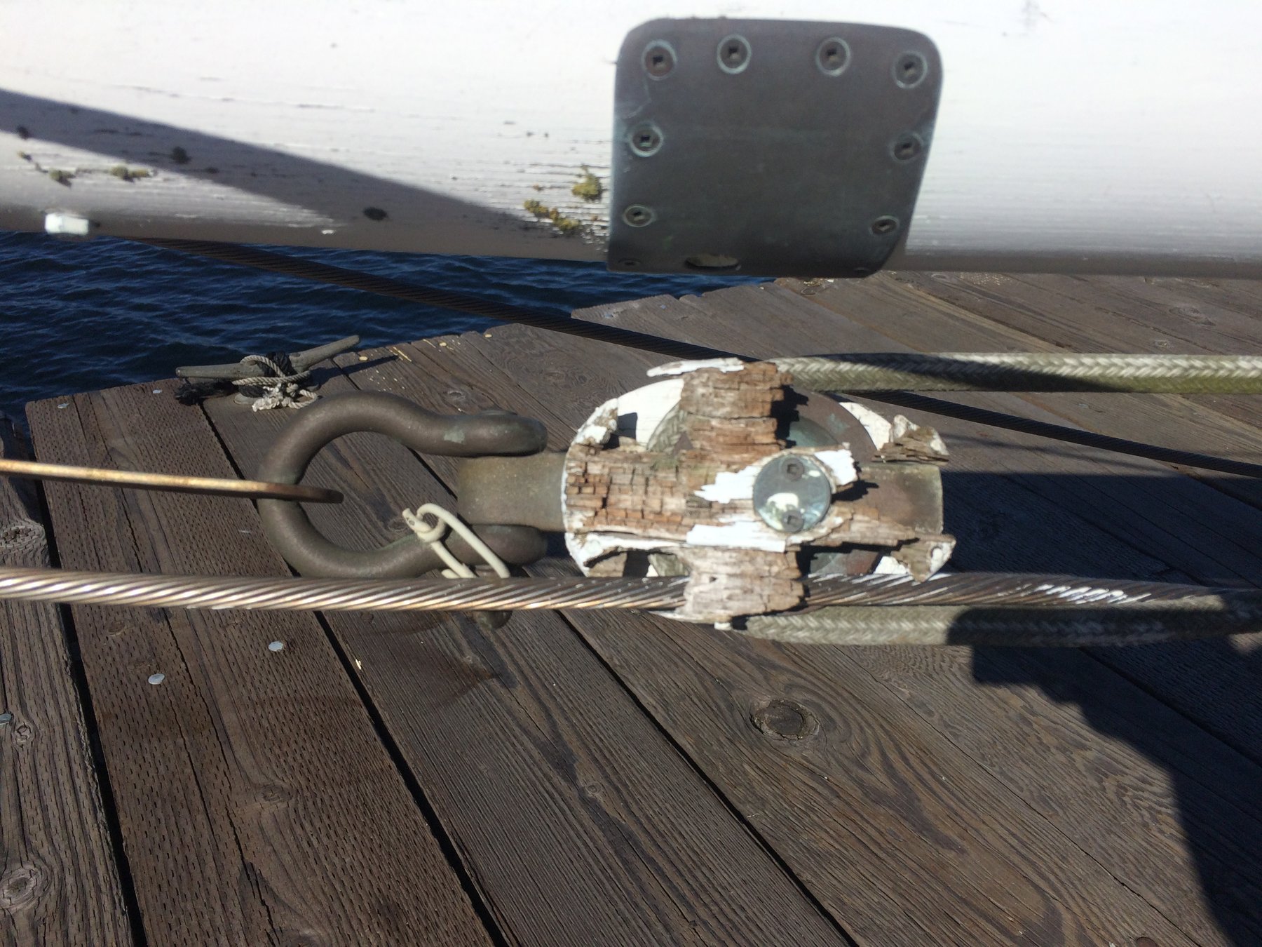 Classic deck hardware and worn wooden planking on the Merry Maiden, a 1946 Philip Rhodes design, showing the character and patina of this vintage Puget Sound sailing yacht.