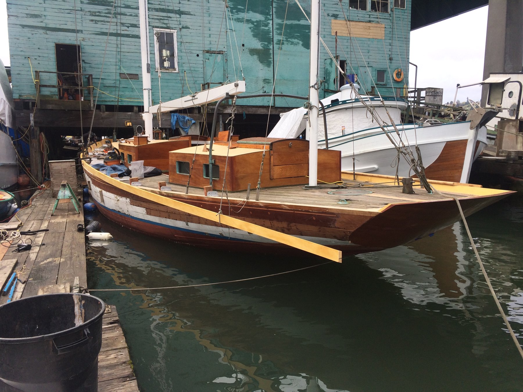 The classic 1946 Philip Rhodes-designed Merry Maiden rests at her moorings in Puget Sound, her wooden hull and traditional lines reflecting decades of Pacific Northwest character and craftsmanship.