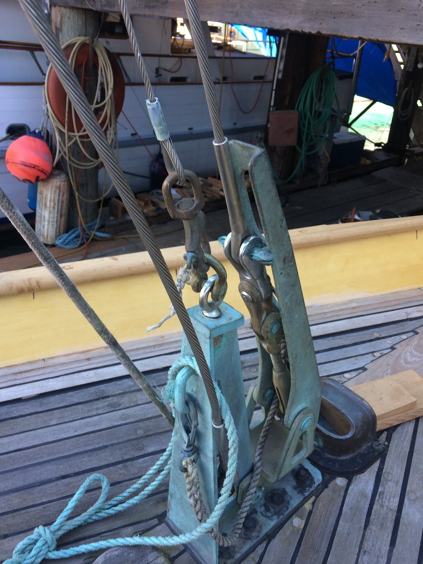 Ornate bronze fittings and turquoise rope showcase the craftsmanship of Merry Maiden, a 1946 classic, secured at her Puget Sound mooring with weathered elegance.