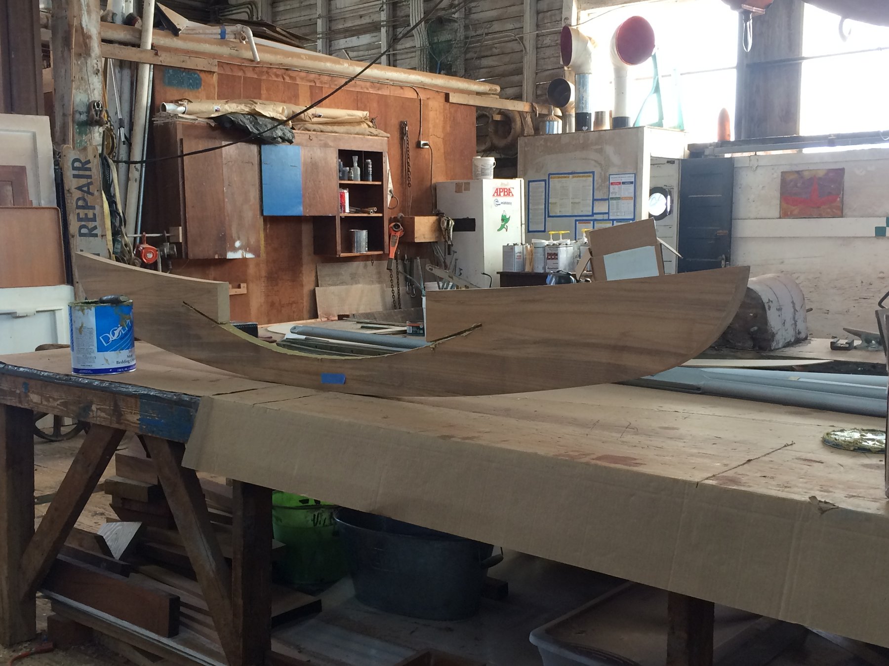 The classic lines of Merry Maiden take shape in the boatyard, her wooden hull under restoration revealing the timeless craftsmanship of this 1946 Philip Rhodes design.