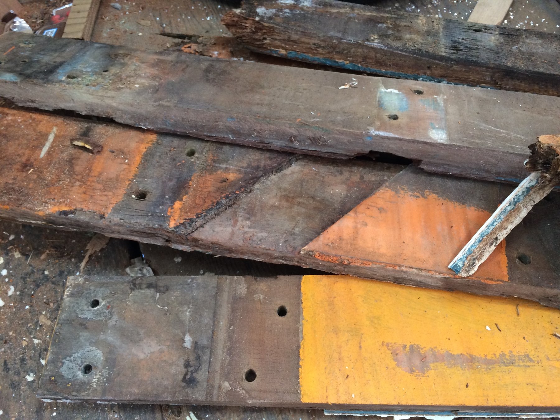 Layers of time and restoration: the Merry Maiden's wooden hull reveals decades of history, with patches of orange primer and weathered wood showing both decay and the ongoing work to bring this 1946 classic back to life.
